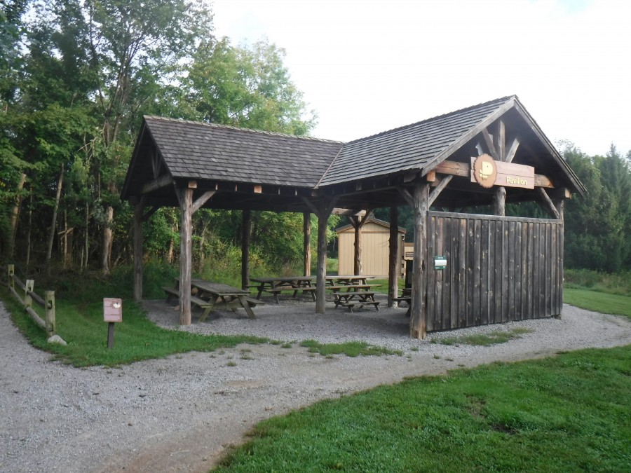 large wooden picnic pavilion with tables